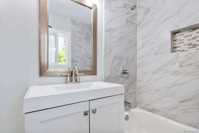 a bathroom with a sink mirror and vanity