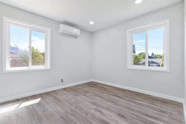 wooden floor in an empty room with a window