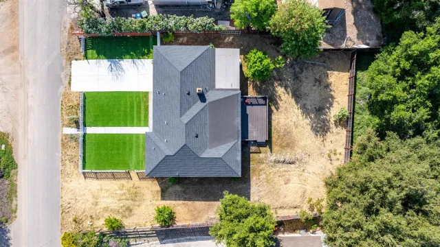 an aerial view of a house with a yard