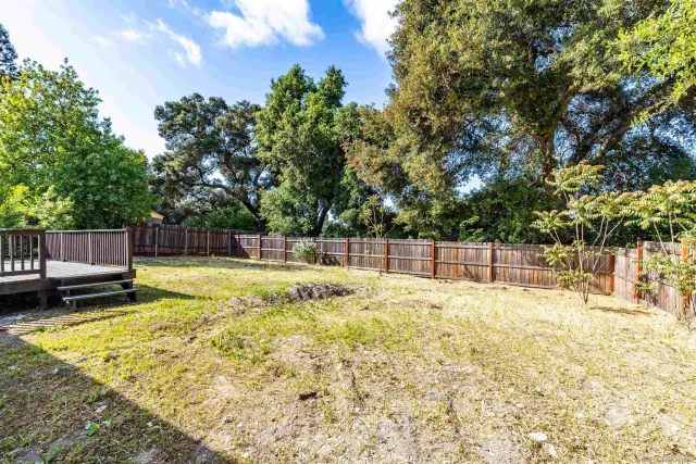 a swimming pool with some trees in the background