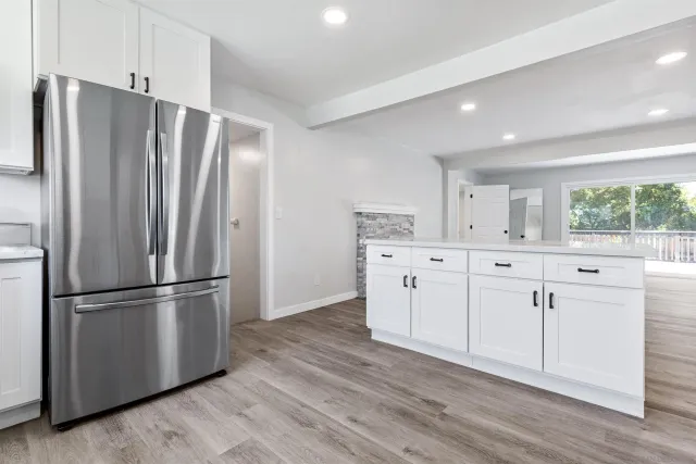 a kitchen with stainless steel appliances a refrigerator sink and cabinets