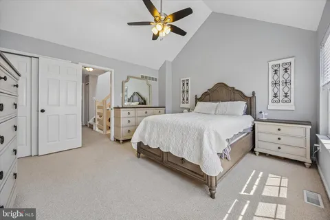 a spacious bedroom with a bed and a chandelier
