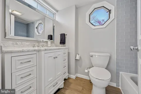 a bathroom with a toilet a sink and mirror