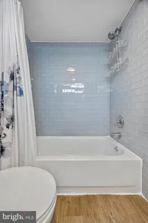 a bathroom with a bathtub and shower