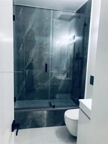 a bathroom with a shower and toilet