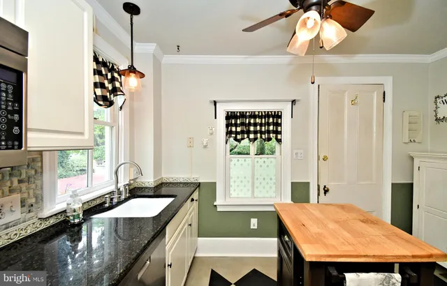 a kitchen with stainless steel appliances granite countertop a sink a stove and a refrigerator