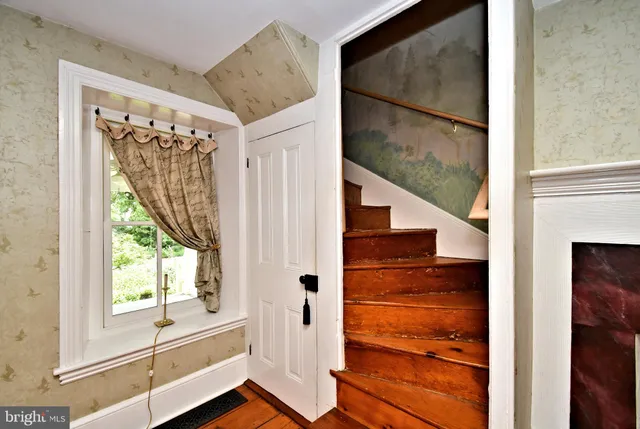 a view of front door of house with wooden floor and windows