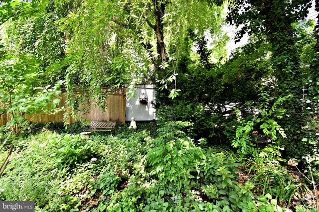an aerial view of a house with garden space and sitting area