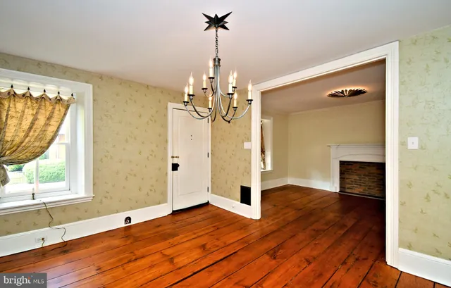 a view of a livingroom with wooden floor and a large window