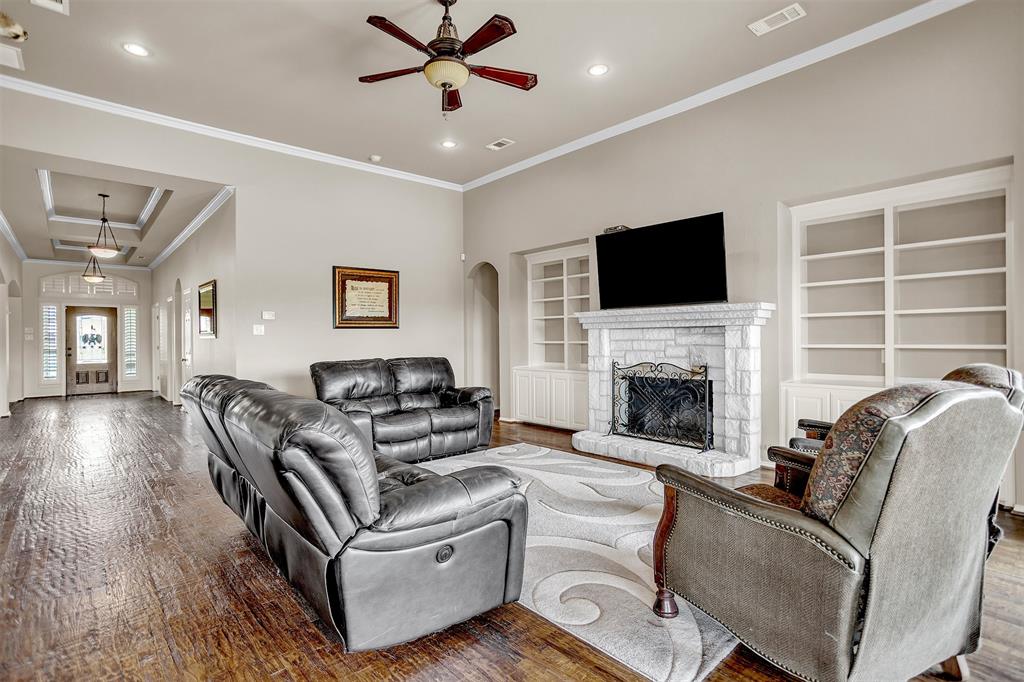 12286 Emerald Ranch Lane North Forney, TX 75126 - Photo 16 of 40 a living room with furniture a flat screen tv and a fireplace