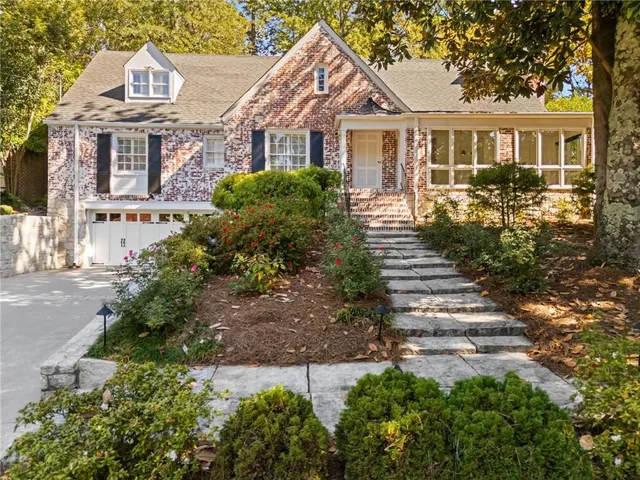a front view of a house with a garden