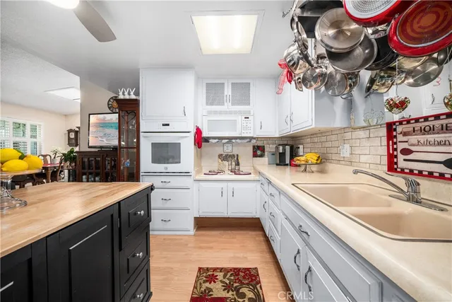 a large kitchen with stainless steel appliances granite countertop a sink dishwasher and a stove