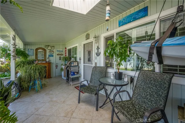 a view of a patio with couches table and chairs and potted plants
