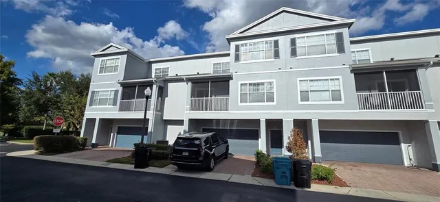 a front view of a house with yard and parking