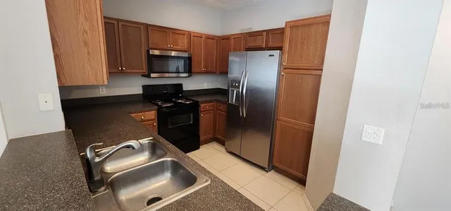 a kitchen with a refrigerator stove and microwave