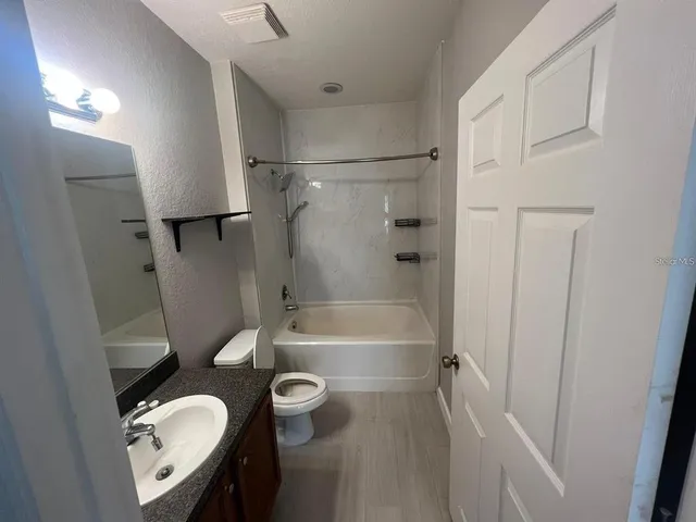 a bathroom with a sink a toilet a bathtub and a shower