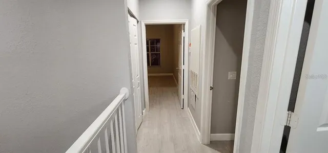 a view of hallway with wooden floor