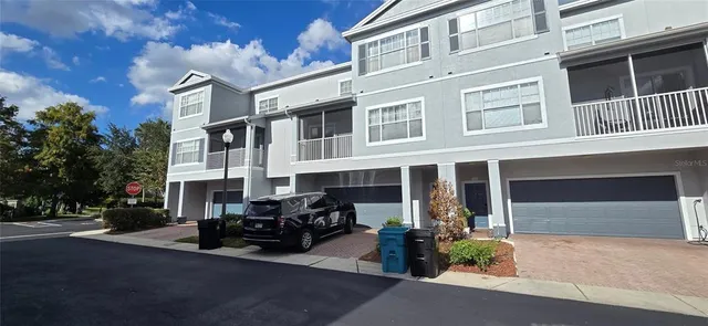 a front view of a building with parking space and a garage