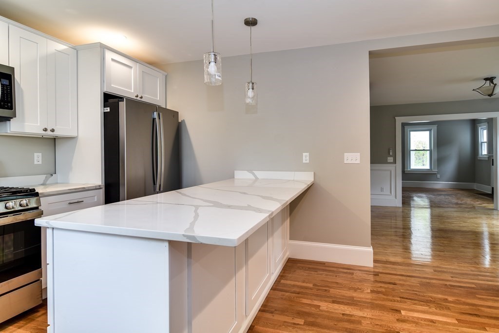 8 Everett Street Sherborn, MA 01770 - Photo 11 of 25 a kitchen with stainless steel appliances a refrigerator and a stove top oven