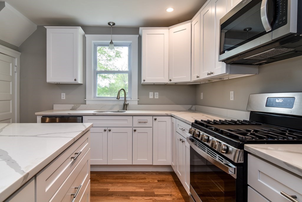 8 Everett Street Sherborn, MA 01770 - Photo 12 of 25 a kitchen with cabinets appliances a sink and a window