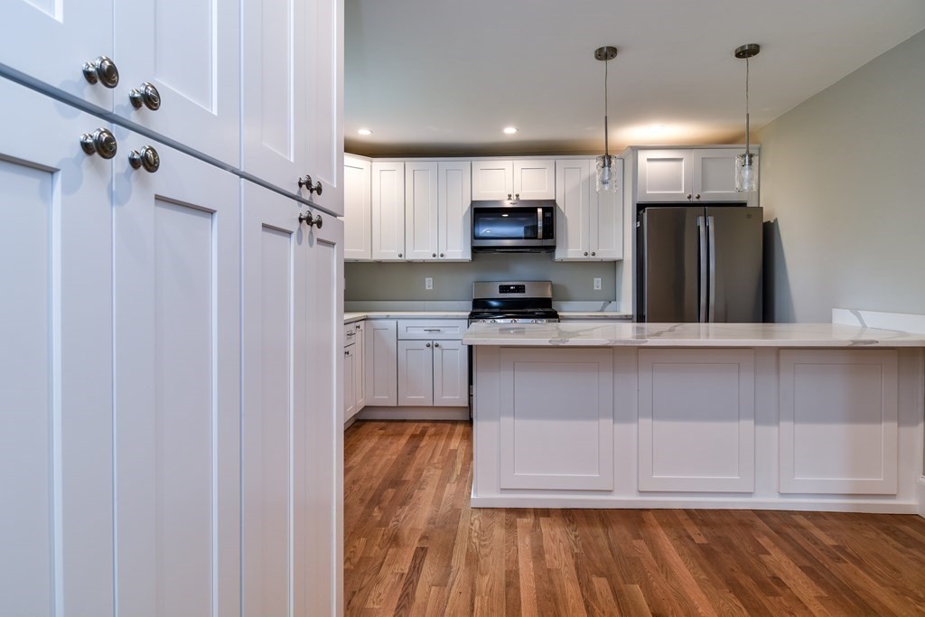 8 Everett Street Sherborn, MA 01770 - Photo 13 of 25 a kitchen with stainless steel appliances granite countertop a refrigerator sink and microwave