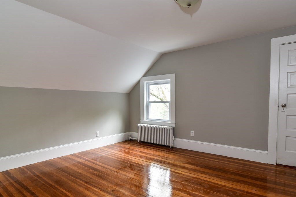 8 Everett Street Sherborn, MA 01770 - Photo 20 of 25 an empty room with wooden floor and windows
