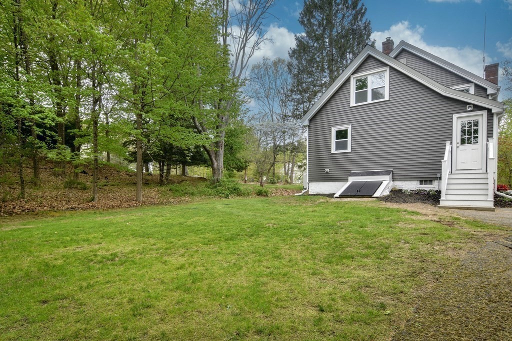 8 Everett Street Sherborn, MA 01770 - Photo 22 of 25 a backyard of a house with table and chairs