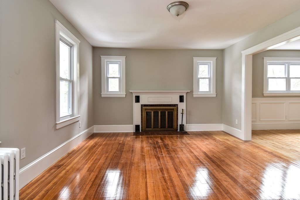 8 Everett Street Sherborn, MA 01770 - Photo 5 of 25 wooden floor fireplace and windows in an empty room