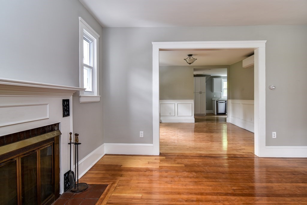 8 Everett Street Sherborn, MA 01770 - Photo 7 of 25 a view of a hallway view with wooden floor and a fireplace