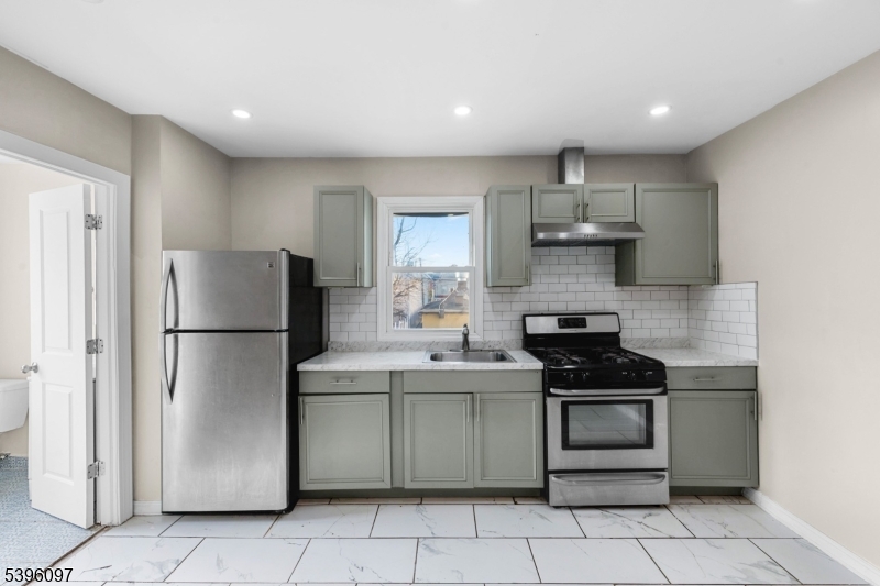 113 Second Street Elizabeth Port, NJ 07206 - Photo 11 of 32 a kitchen with a stove a refrigerator and a sink