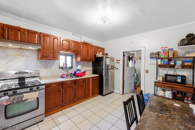 113 Second Street Elizabeth Port, NJ 07206 - Photo 12 of 34 a kitchen with stainless steel appliances granite countertop a refrigerator stove and sink
