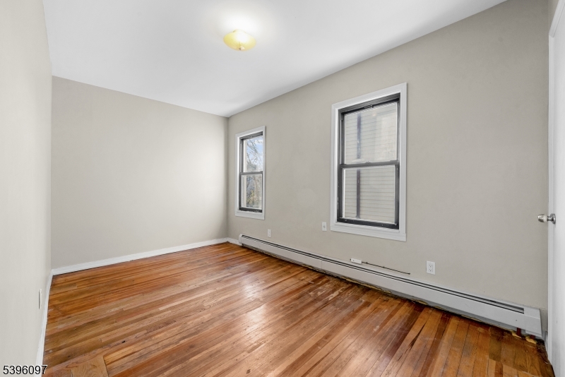 113 Second Street Elizabeth Port, NJ 07206 - Photo 14 of 32 a view of an empty room with wooden floor and a window