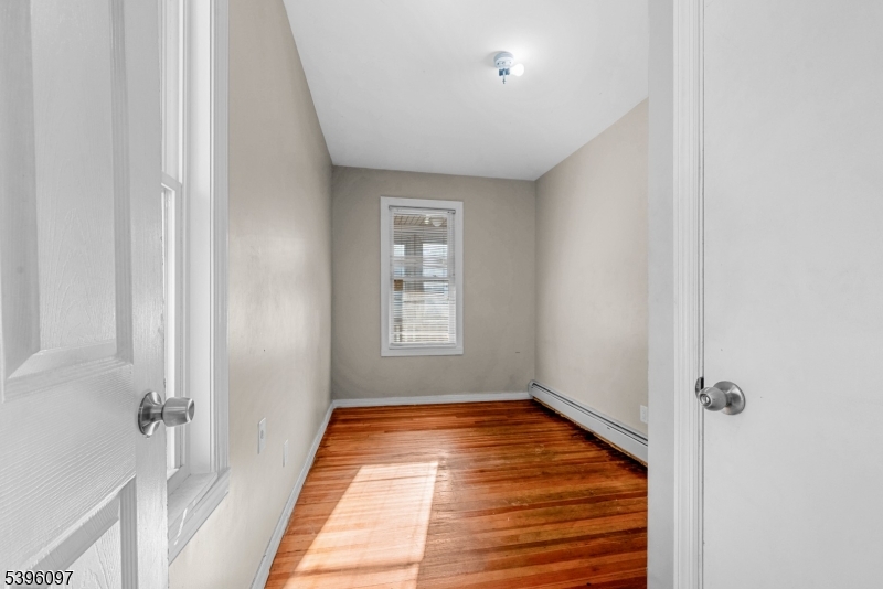 113 Second Street Elizabeth Port, NJ 07206 - Photo 15 of 32 a view of an empty room with wooden floor and a window