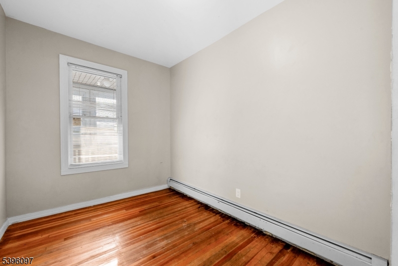113 Second Street Elizabeth Port, NJ 07206 - Photo 16 of 32 an empty room with wooden floor and windows