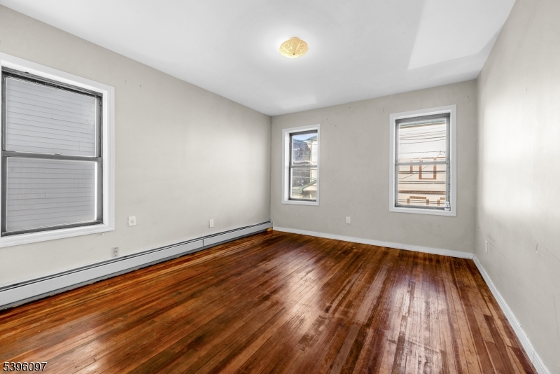 113 Second Street Elizabeth Port, NJ 07206 - Photo 17 of 32 a view of an empty room with wooden floor and a window