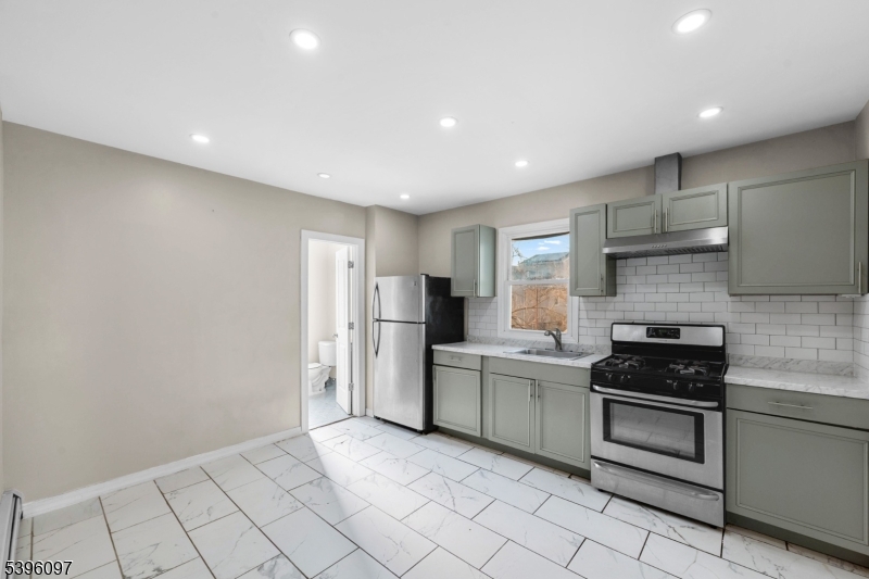 113 Second Street Elizabeth Port, NJ 07206 - Photo 18 of 34 a kitchen with white cabinets and appliances