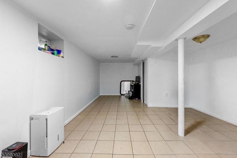 113 Second Street Elizabeth Port, NJ 07206 - Photo 3 of 34 a view of a livingroom with wooden floor and cabinet