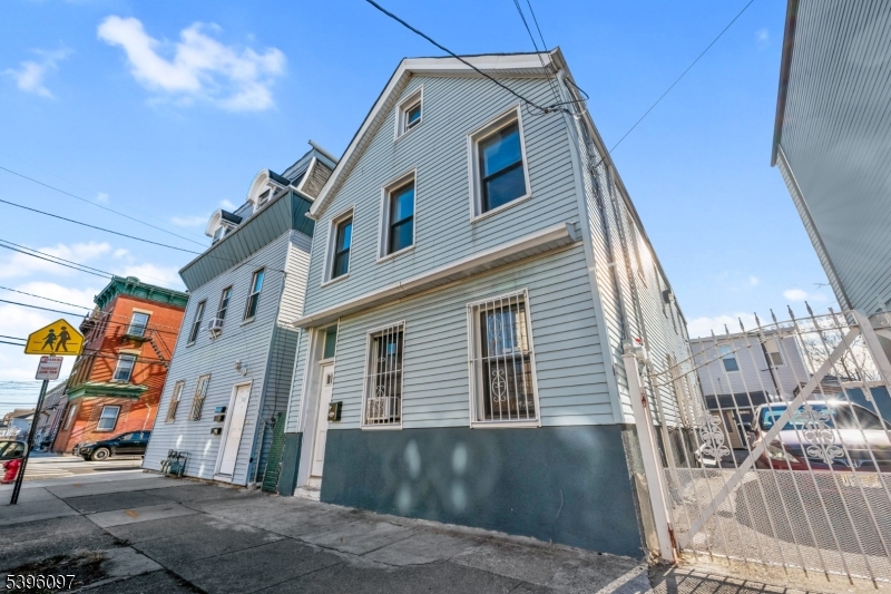 113 Second Street Elizabeth Port, NJ 07206 - Photo 34 of 34 a front view of a building with multi story residential apartment building and entryway