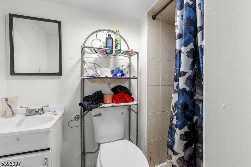 113 Second Street Elizabeth Port, NJ 07206 - Photo 4 of 34 a bathroom with a toilet sink vanity and mirror