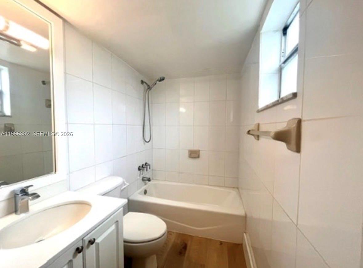 444 Southwest 4th Street, Unit 204 Miami, FL 33130 - Photo 4 of 11 a bathroom with a sink a toilet and a bathtub