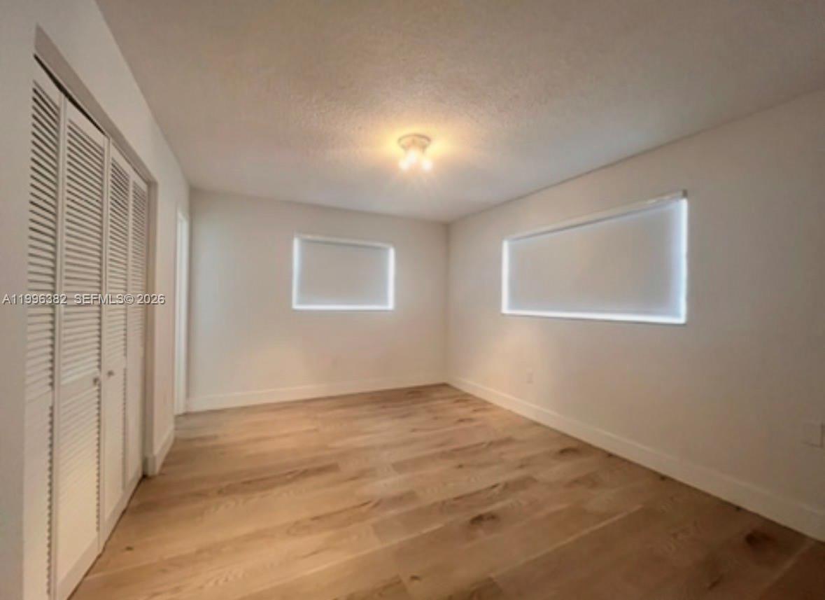 444 Southwest 4th Street, Unit 204 Miami, FL 33130 - Photo 5 of 11 an empty room with windows