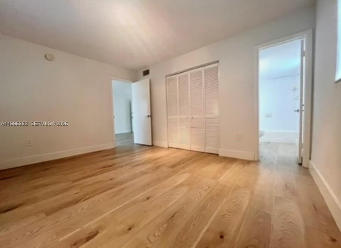 444 Southwest 4th Street, Unit 204 Miami, FL 33130 - Photo 6 of 11 a view of an empty room and wooden floor