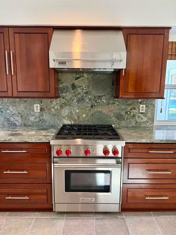a kitchen with a dining table chairs and refrigerator