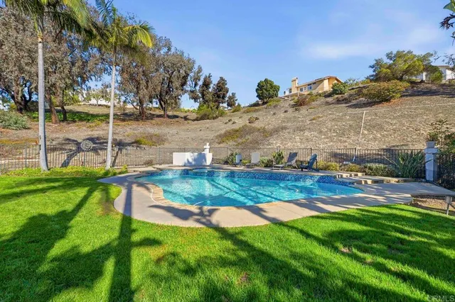a view of a swimming pool with a yard