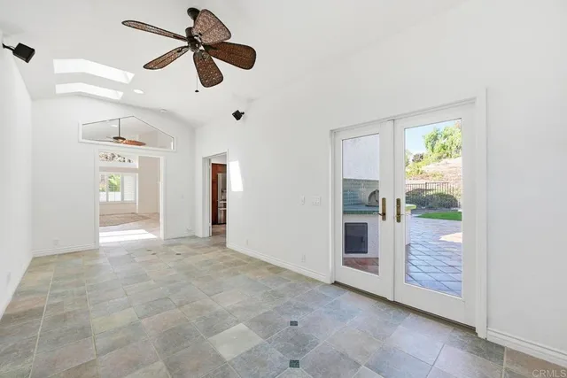 a spacious bathroom with a granite countertop sink mirror and a bathtub
