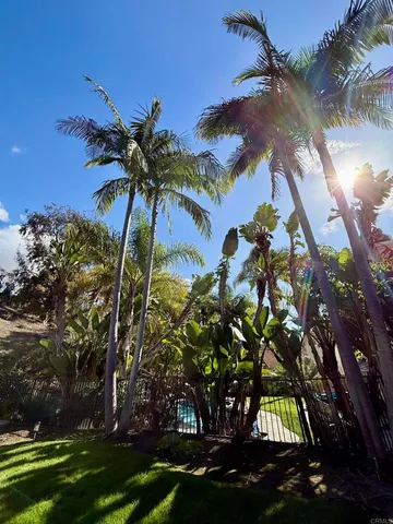 a view of a house with swimming pool and a yard