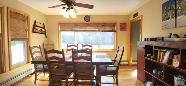 a view of a dining room with furniture window and wooden floor