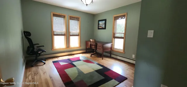 a living room with a bed furniture and a window