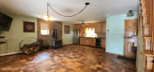 a view of a livingroom with furniture and a kitchen