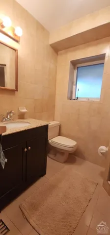 a bathroom with a sink a toilet and mirror
